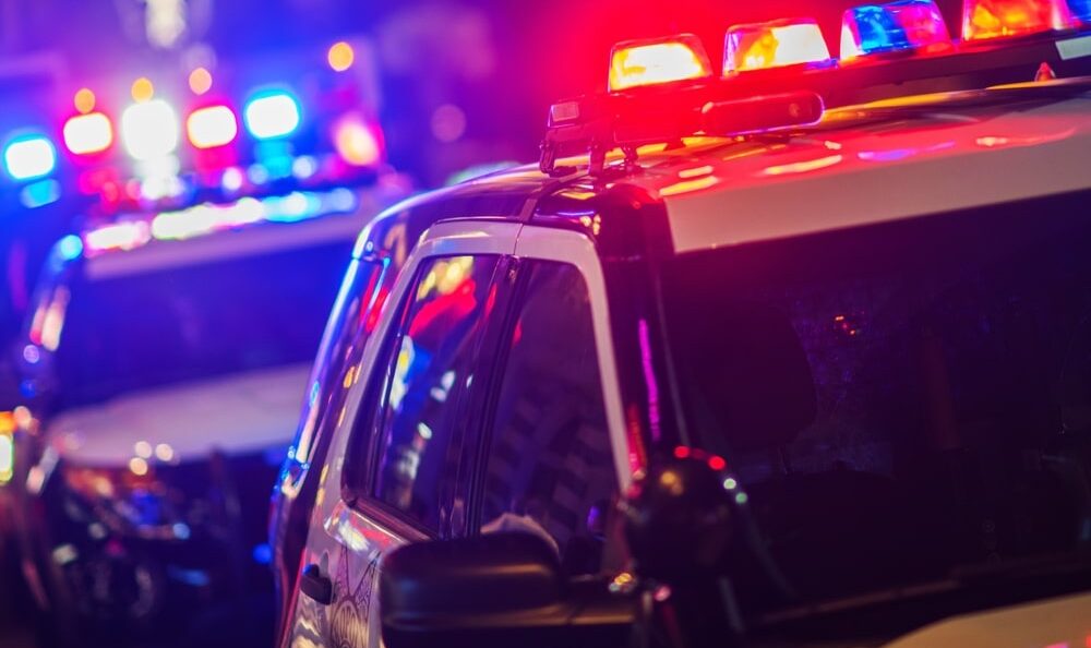 Police vehicle with flashing lights during a night-time traffic stop